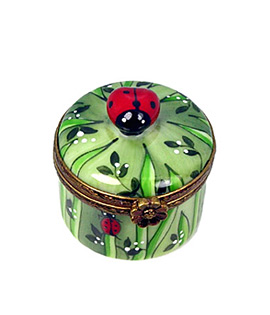 small round Limoges box with ladybugs and grass