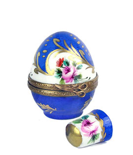 Small egg Limoges box holding thimble